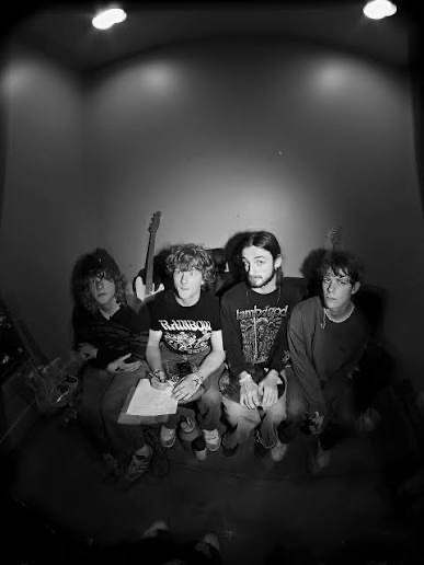 The four members of Infielder seated together in the studio